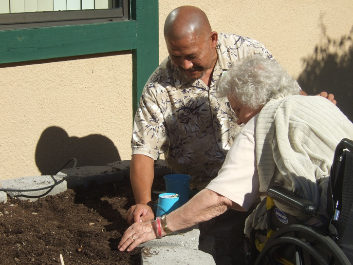 Activity staff help seniors care for their gardens